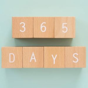 365 days; Seven wooden blocks with “365 DAYS” text of concept. 365 days; Seven wooden blocks with "365 DAYS" text of concept.